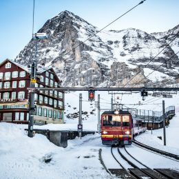 The Jungfraujoch train comes into Kleine Scheidegg on a cold winter morning beneath the Eiger Nordwand, Switzerland